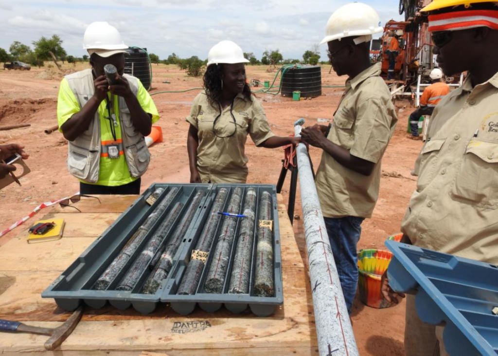 Staff conducting orientation measurements on mineralisation