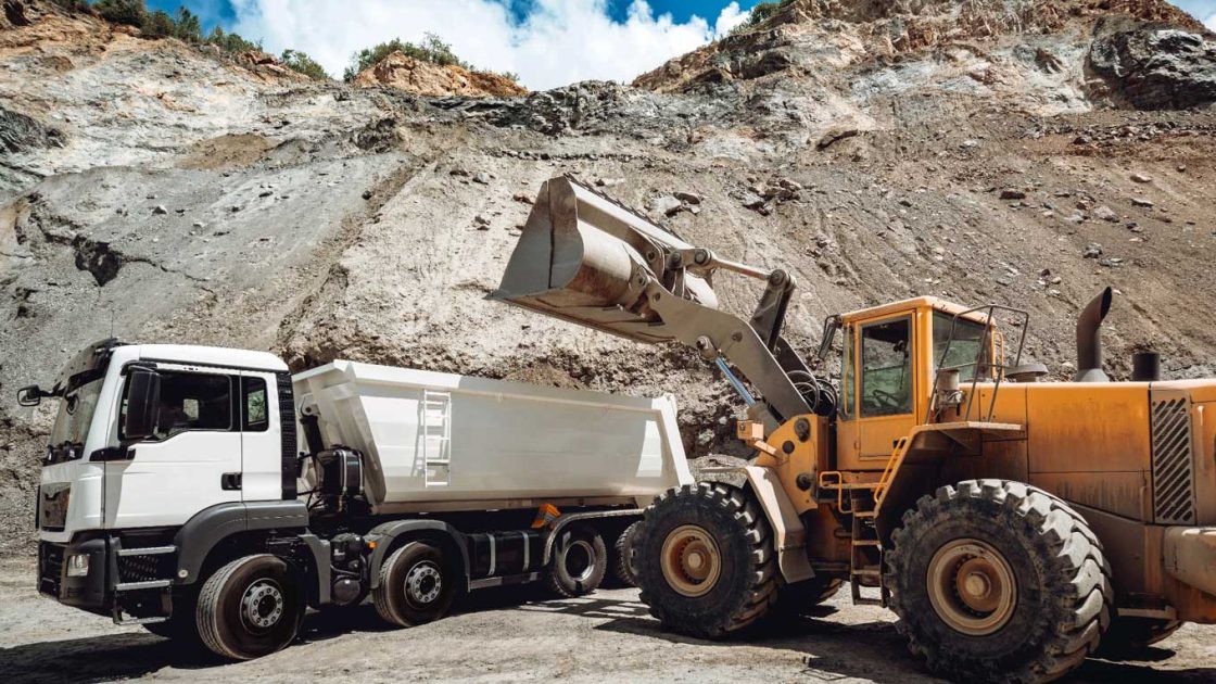 Image of two mining trucks at a site